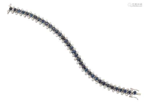 A sapphire and diamond bracelet, the central line of oval sapphires between single lines of