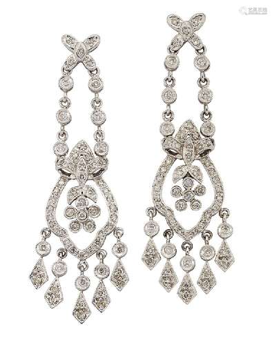 A pair of diamond pendent earrings, of tapered form, each with flowerhead within a shaped frame with