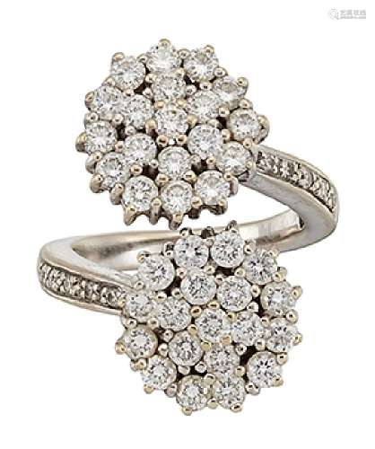 A diamond cluster ring, of crossover design, the brilliant-cut diamond twin clusters to brilliant-