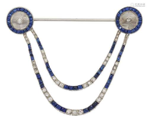 An Art Deco rock crystal, sapphire and diamond jabot pin, each terminal composed of a circular
