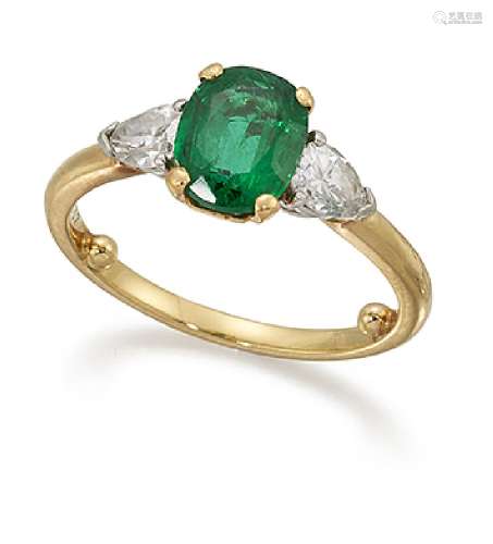 An emerald and diamond three stone ring by Cartier, the oval emerald between pear-cut diamond single