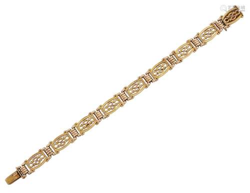 An Edwardian gold flexible bracelet, of fancy gate-link design with reeded connecting links, c.