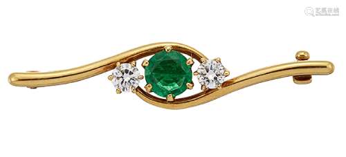 An 18ct gold, emerald and diamond three stone brooch by Cartier, the circular-cut emerald between