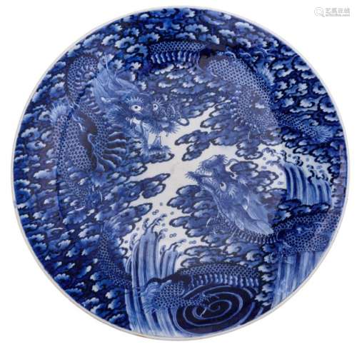 A Japanese blue and white dragon decorated plate, …