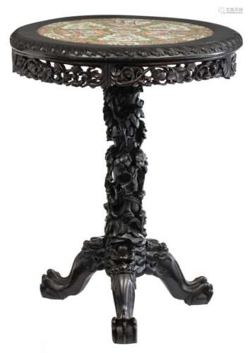 A Chinese hardwood carved table with a porcelain C…