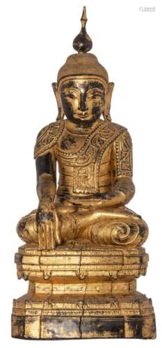 An Oriental wooden gilt decorated seated figure of…