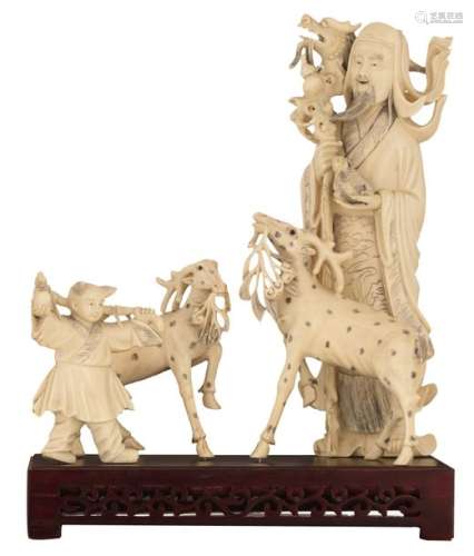 A Chinese ivory group depicting a scholar with a d…