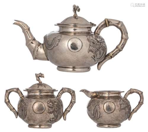 A Chinese three piece silver tea set with dragon d…
