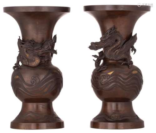 A pair of Oriental bronze vases, relief decorated …