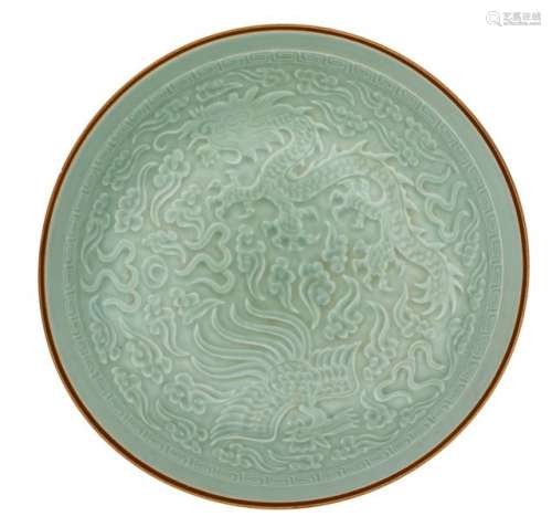 A Chinese celadon glazed dish, relief decorated wi…