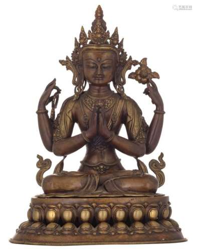 A Tibetan bronze statue of a seated four armed Bud…