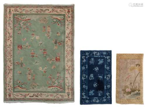 Three Chinese woollen rugs, one decorated with ant…