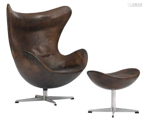 A brown leather upholstered 'Egg chair' and a matc…