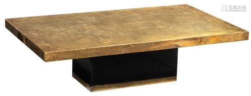 An etched brass coffee table, supported by a black…