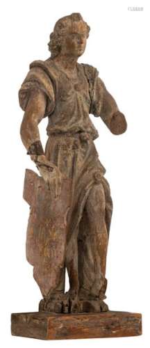 A walnut sculpture of an archangel holding a coat …