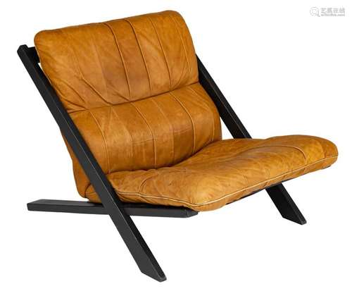 A black painted wooden lounge chair with tan leath…