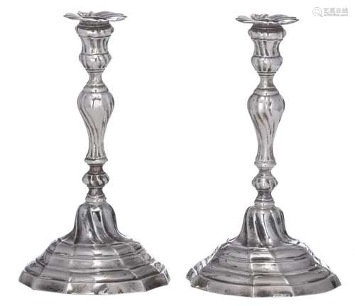 A pair of silver Rococo candlesticks, indistinctly…