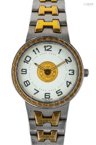 HERMES Montre “Sellier” en acier et métal doré Lun…