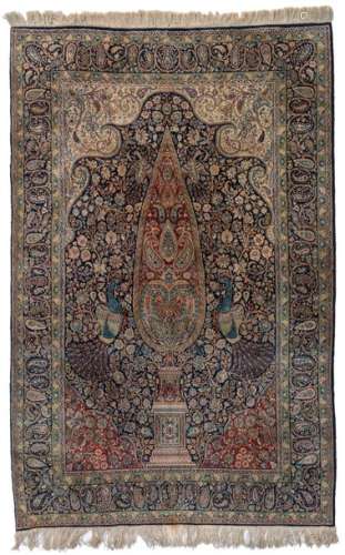 An Oriental Kirman woollen rug, decorated with pea…