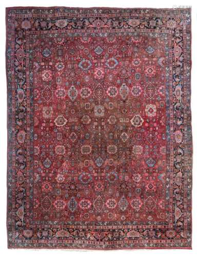 A large Oriental woollen rug, decorated with geome…
