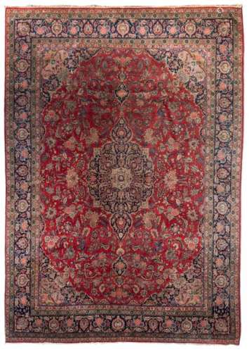 A large Oriental floral decorated woollen rug, 440…