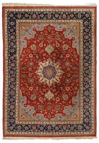 An Oriental woollen rug, floral decorated, with a …