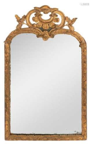 A richly sculpted Baroque gilt wooden wall mirror,…