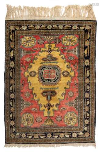 An Oriental silk rug, decorated with geometric mot…