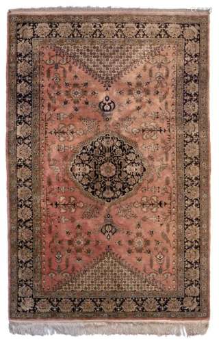 An Oriental silk and woollen rug, decorated with b…