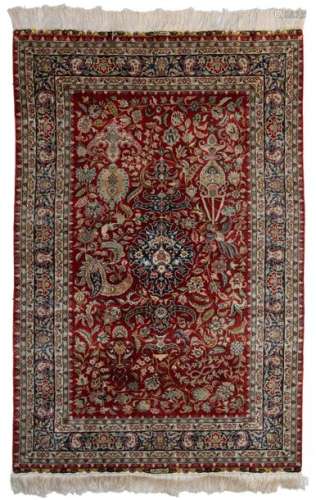An Oriental silk rug, decorated with birds and flo…