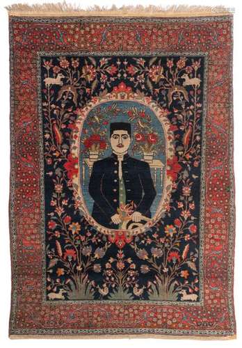 An Oriental woollen rug, decorated with a male fig…