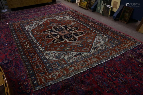 An antique Persian Heriz carpet