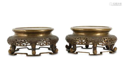 A PAIR OF TIBETAN BRONZE CIRCULAR STANDS.