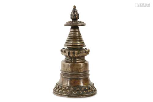 A TIBETAN BRONZE STUPA.