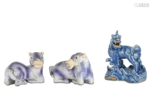 A CHINESE BLUE-GLAZED BISCUIT MODEL OF A QILIN AND A PAIR OF PURPLE-GLAZED ANIMALS.