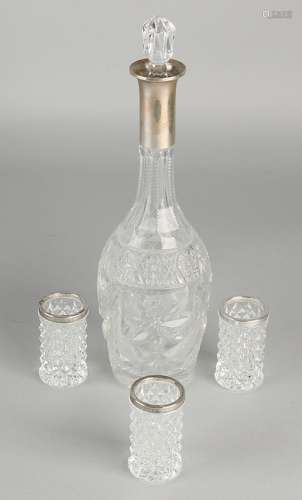 Crystal decanter and three glasses with silver border,