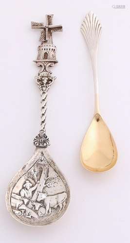 Two silver spoons, 835/000, with a spoon with sugar