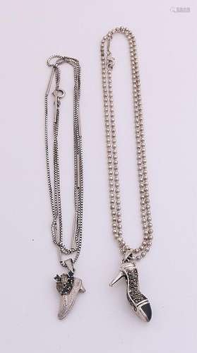 Two silver necklaces with pendants, various levels, a