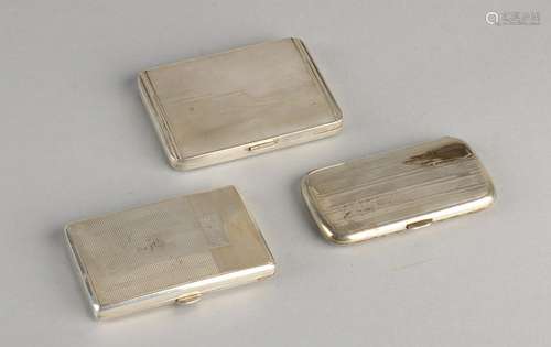 Three flat rectangular boxes with silver hinge lines