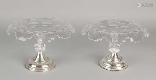 Two crystal tazza with folded edge placed on a round