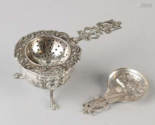 Silver tea sieve with drip tray, and tea thumb,