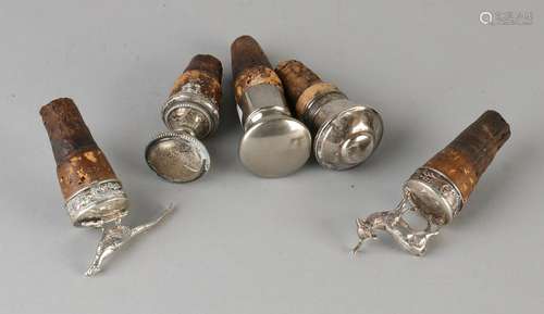 Five decorative cork, four silver; one with pheasant