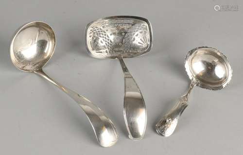 Three silver spoons, 833/000, one dispensing spoon with