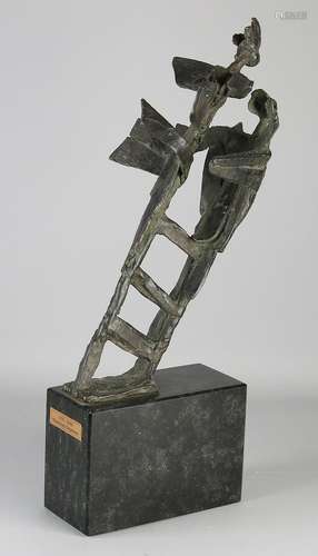 Large modern bronze sculpture on black marble base.