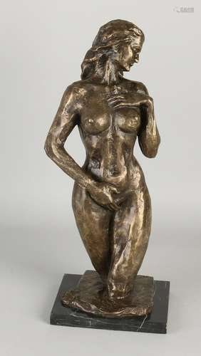 Bronze women figure in black marble base. 21st century.