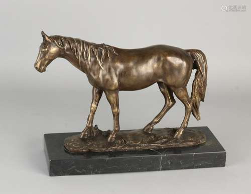 Bronze horse on black marble base. 21st century. Size: