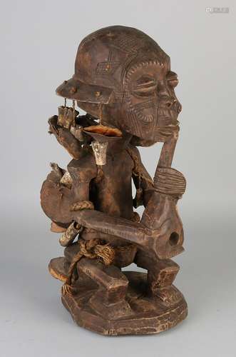 Large African softwood inserted pipe smoking figure