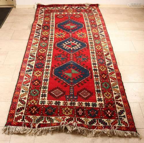 Persian rug in the colors red, blue, cream. Size: 119 x