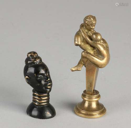 Two ancient bronze briefverzwaarders. One times erotic,