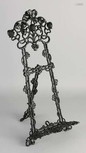 Metal easel in art nouveau style. Whip with floral